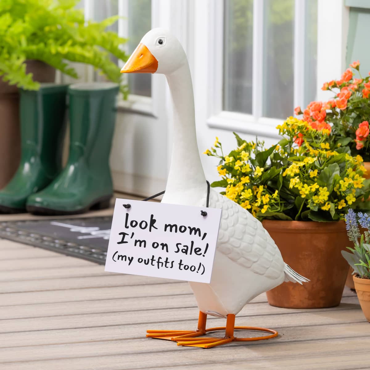 Giddy the porch goose with a sign that reads "Look mom, I'm on sale! (my outfits too!)"